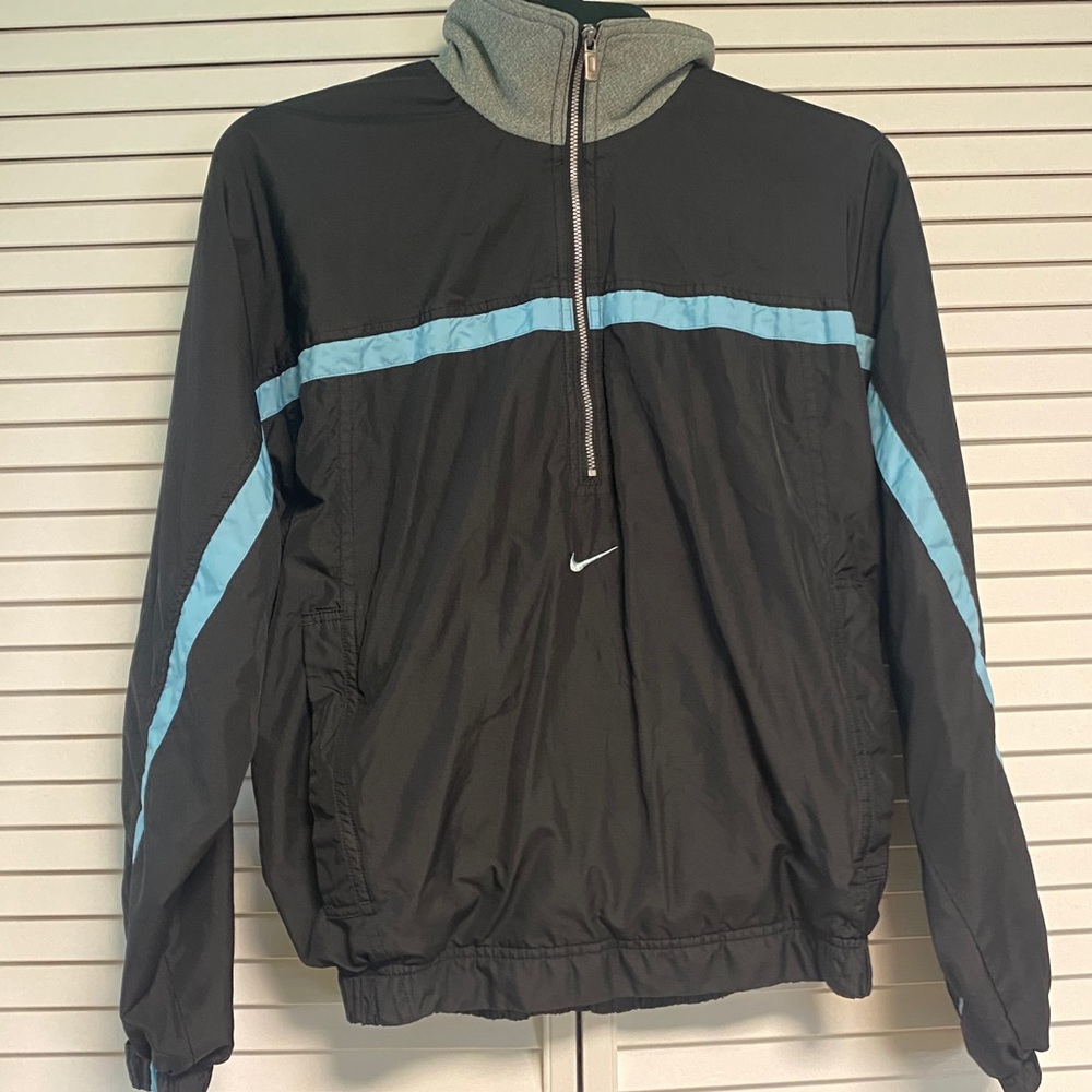 Nike female half zip, black with blue accents.